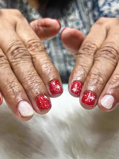 Another angle of these adorable Christmas nails. The glittery red and white combination is a timeless choice for the holiday season, perfect for clients of all ages.
