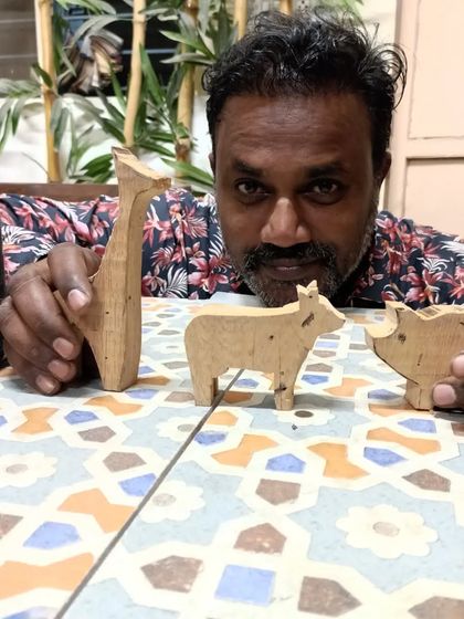 Ajesh with some of the experimental animal cutouts he made. He's building a catalog of home decor articles for his new business, and these wooden animals are a great start.