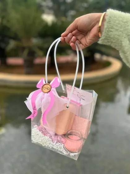 A simple and sweet pink-themed hamper in a clear acrylic bag, perfect for a sister.