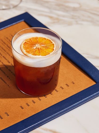 A beautiful, dark-hued sour cocktail resting on our menu. The vibrant colour and frothy top make it as appealing to the eye as it is to the palate.