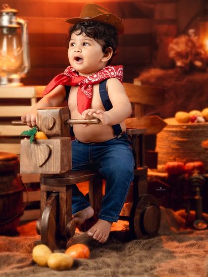 Looking off to the side with wonder, this little cowboy is lost in his imaginative world.