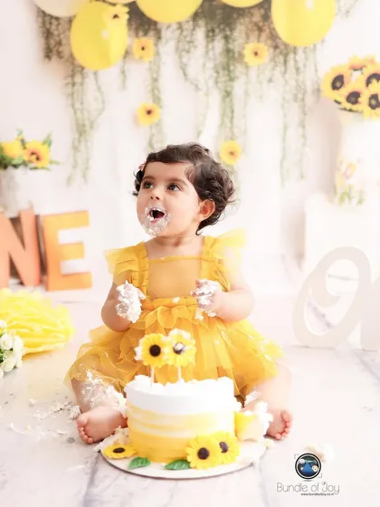 Nothing says "happy first birthday" like a cake smash! This little girl is having the best time with her sunflower themed cake, a perfect example of the pure, unscripted joy I love to capture.