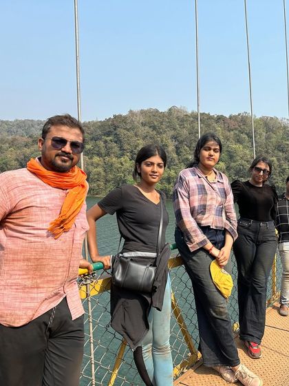 A group of friends posing on a suspension bridge, a common and exciting feature in the ghats.
