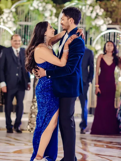 A candid moment from a Sangeet night, where the couple shares their first dance. The backdrop we designed features cascading crystal strings and white floral arrangements, creating a sparkling, glamorous ambiance perfect for an evening of celebration.
