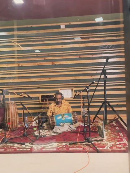 A percussionist with his beautifully painted drum. The visual artistry of the instruments is as important as their sound.