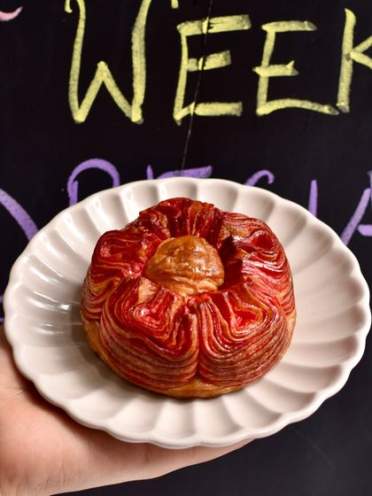Our Rakhi Bloom Croissant is as beautiful as it is delicious. The intricate petal-like layers of this chocolate-hazelnut croissant are shaped by hand, creating a stunning flower that's perfect for gifting.