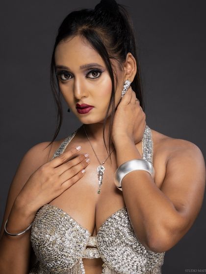 A direct-to-camera shot of the model in the silver outfit, exuding confidence.