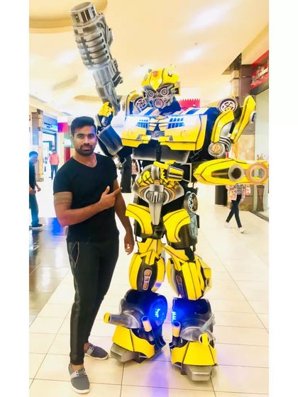 A guest poses with our impressive Bumblebee robot costume. This character is a huge hit at corporate family days, tech events, and of course, kids' birthday parties.