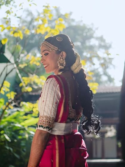 A bride, backlit by the sun, her joy radiating as she smiles. The natural light creates a beautiful, soft-focus effect.