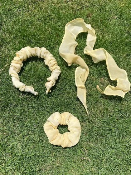 My handmade hair accessories: a scrunchie headband, a versatile hair ribbon, and a classic scrunchie, all dyed with onion skins. Perfect for managing my curly hair in style!