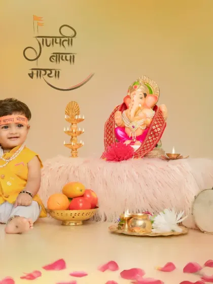 This little one is dressed in a bright yellow outfit for his Ganpati themed shoot. The warm background and scattered flower petals add to the festive and cheerful atmosphere of the portrait.