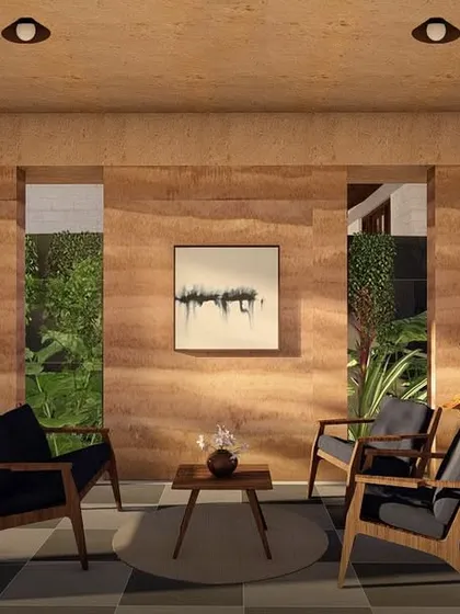 An interior view of the rammed earth villa in Morjim, where the natural texture of the earth walls becomes the main feature of the room.