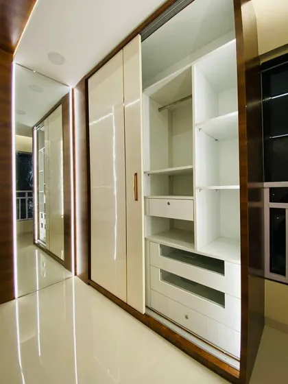 This is the inside of a well-planned wardrobe. We use a combination of hanging space, deep drawers, and shelves to create a customized layout that suits your specific storage needs.