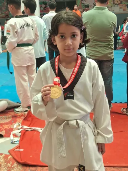 Meet one of our young champions. This student proudly displays her gold medal, a testament to her focus, hard work, and the winning spirit we nurture at the academy.