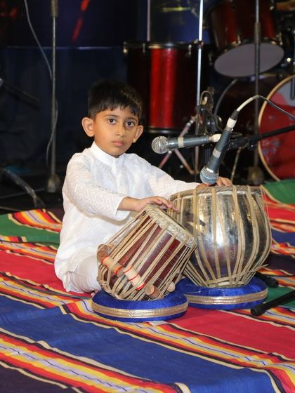 Another shot of young Reyansh on stage, completely at ease with his instrument and the audience.