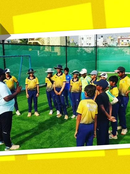 A coach addressing a group of young players. Clear communication and instruction are key to our coaching method.