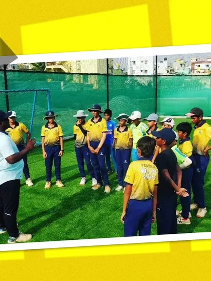 A coach addressing a group of young players. Clear communication and instruction are key to our coaching method.