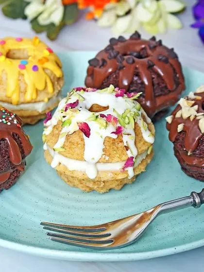 An assortment of gourmet donuts with various chocolate and nut toppings. This shot showcases the variety and richness of a bakery's offerings in a single, appealing image.