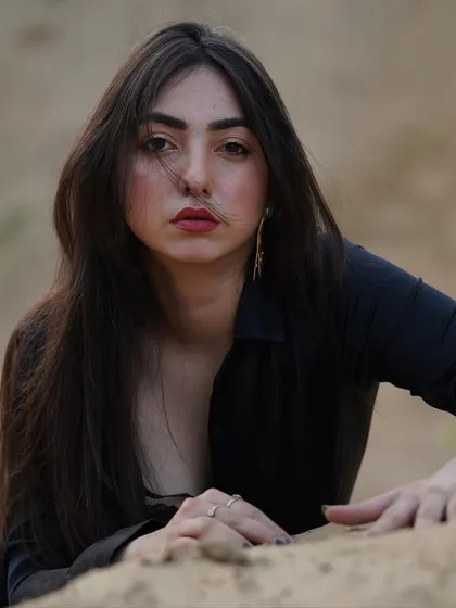 A powerful, direct-to-camera portrait from the sand shoot, with a focus on the raw and intense expression.