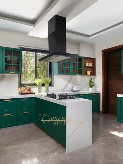 A bold and vibrant kitchen design featuring rich emerald green cabinetry paired with white marble countertops for a fresh and luxurious feel.