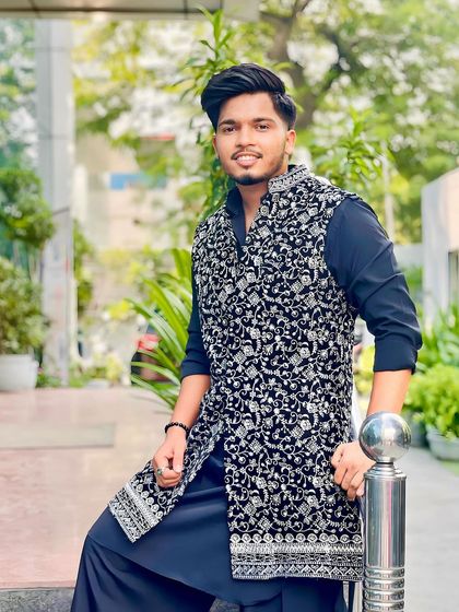 A client ready for Diwali in a black kurta paired with a stunning black and silver embroidered sleeveless jacket. A perfect layered look for any festival.