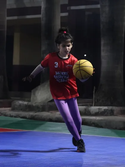 A young girl dribbles with determination. Every session is a chance to build confidence and skill.