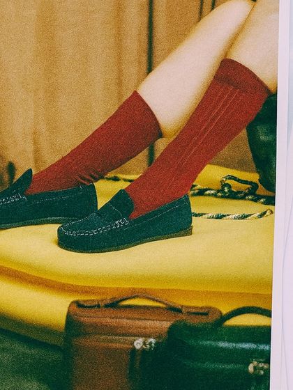 A styled shot showing how our navy suede loafers can be paired for a preppy, yet relaxed look. The focus is on comfort and personal expression, showing the versatility of these handmade shoes.