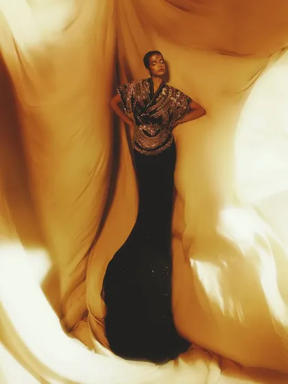 A full-length shot that feels like it's straight out of a high-fashion magazine, with the golden light enveloping the model.