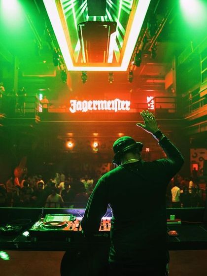 A picture of me in my element, with the Jägermeister and Sunburn logos lighting up the background.