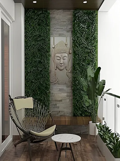 We designed this balcony as a tranquil space for meditation and reflection. The focal point is a serene Buddha face carving set against a stone-clad wall, flanked by vertical green panels that bring a sense of calm and nature to the setting.