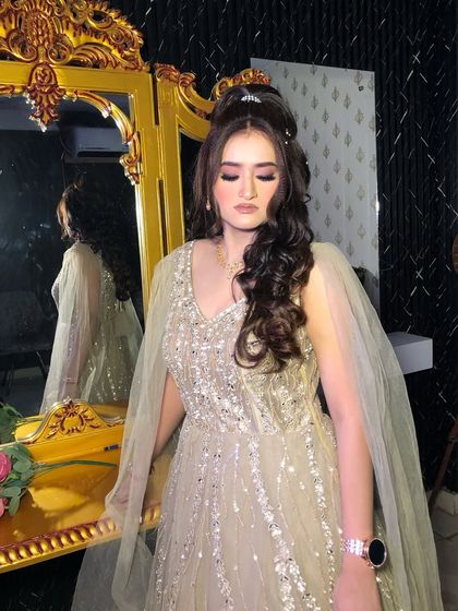 Another angle of this beautiful engagement look. The high ponytail and soft curls add a touch of modern glamour.