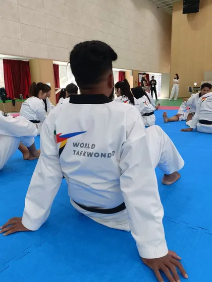 The back of my dobok, showing my affiliation with World Taekwondo during a training session.
