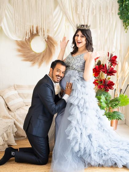 A fun and playful shot of the dad-to-be listening to the baby bump. The couple's expressions are full of excitement and happiness.