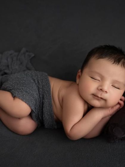 Capturing a fleeting, sleepy smile. These little moments are what make each newborn session so special and unique.