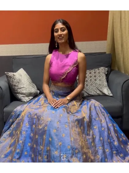 A beautiful custom lehenga in blue brocade, paired with a modern magenta sleeveless blouse. This outfit can be styled as a lehenga or a half saree for versatile occasion wear.