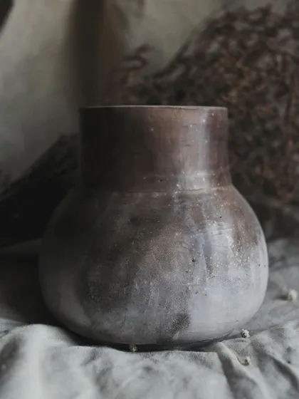 I call this pit-fired vase 'Stardust'. I achieved this subtle, speckled effect by throwing sawdust onto the piece when it was still hot from the fire. It’s a beautiful, earthy piece for dry arrangements.