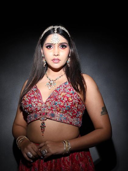 A direct, powerful portrait. The makeup is strong and confident, with a focus on a flawless complexion and striking eyes, demonstrating a look that is perfect for studio photography.