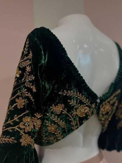 The elegant V-shaped back of our green velvet zardosi blouse, with delicate ruching along the neckline for a refined finish.