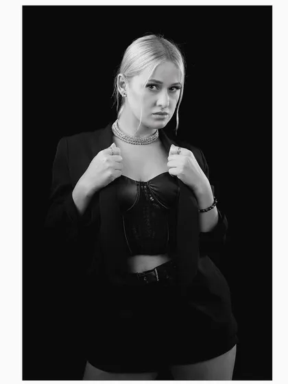 Another powerful pose from the black and white blazer series, with the model adjusting her jacket.