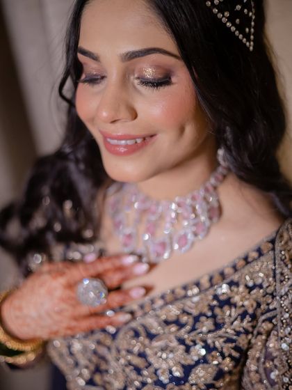 A beautiful, happy moment captured. The bride's glowing skin, soft smile, and sparkling jewelry make this a perfect example of a radiant sangeet look.