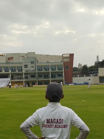 Dreaming big from a young age. One of our U-12 players watches the game unfold during a KSCA League match, embodying the focus and ambition we instill in every student.