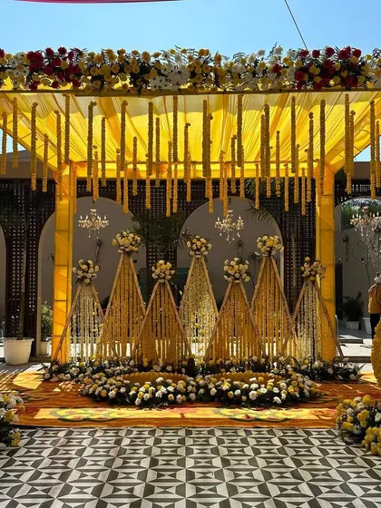 For a vibrant Haldi ceremony, we designed this stunning mandap drenched in shades of yellow. The setup includes a canopy with hanging floral strings, traditional marigold decorations, and a beautiful stage, making it the perfect backdrop for this joyous pre-wedding ritual.