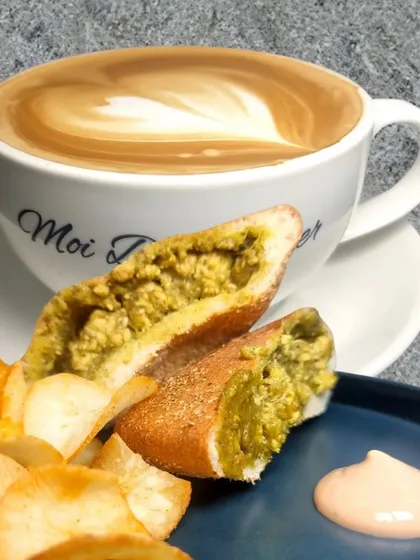 The perfect pairing. A hot, creamy Cafe Latte with my Paneer Cafreal Poee Sandwich, served with crispy kappa chips and a side of mayo dip. It's a comforting and indulgent meal.