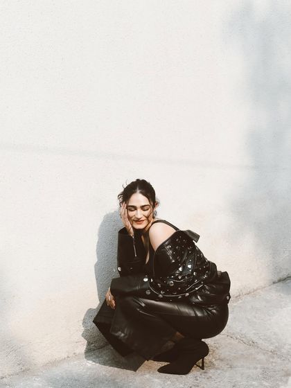 A candid, happy moment with Kavya Trehan in a leather outfit. The contrast between the tough material and her soft smile is what makes this shot special.