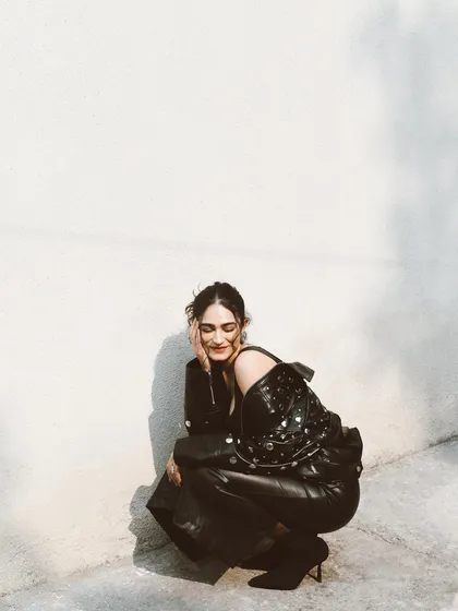 A candid, happy moment with Kavya Trehan in a leather outfit. The contrast between the tough material and her soft smile is what makes this shot special.