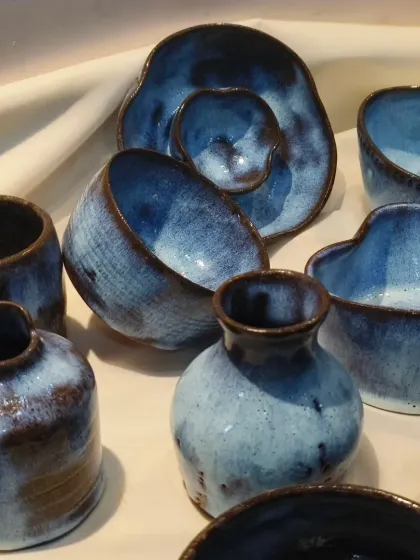 A closer look at the beautiful, flowing blue glaze on these terracotta pieces. The reaction between the glaze and the clay body creates unique, unpredictable patterns.