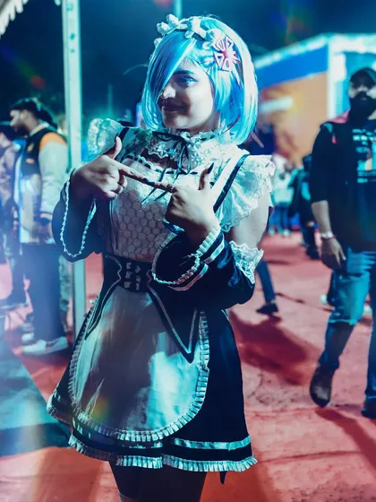 A full-body shot of the REM cosplay, showcasing the detailed maid outfit against the event backdrop. This provides a complete view of the costume, perfect for documenting the full effort of the cosplayer.
