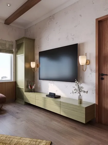 A detail of the media console, finished in a soft green that adds a subtle pop of color to the earthy and rustic palette.