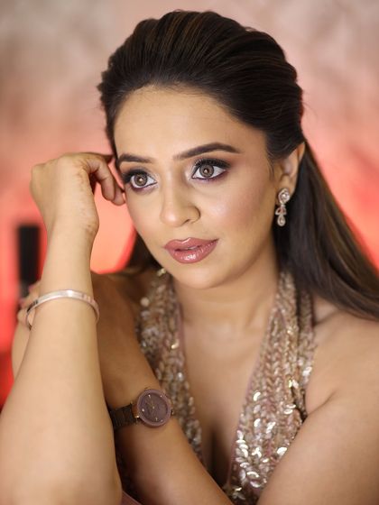 A pensive, beautiful shot. The focus is on her flawless skin and the soft, shimmering eye makeup.