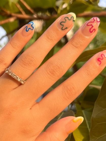 A closer look at the colorful abstract squiggles in natural light. This style is perfect for someone who wants a unique and playful manicure.